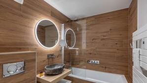 A modern bathroom with wooden walls, a stone basin sink, two round mirrors, a glass-enclosed shower, and a white bathtub. - THELEME 102 (CHATEL)