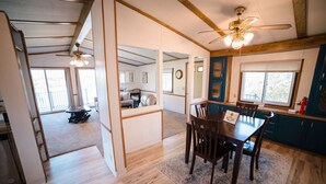 A spacious kitchen with wooden cabinets, a dining table, and a ceiling fan. - Serene 3-Bedroom Getaway with Stunning Lake Views (Aberdeen)
