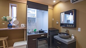 A compact kitchen with a sink, stove, and storage cabinets. - Travel time Setsugekka (Osaka)