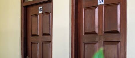Two wooden doors with numbers 103 and 102, indicating room numbers.
