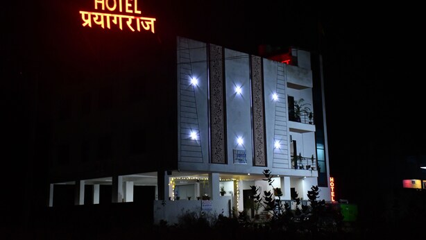 A multi-story hotel with illuminated signage and a modern facade.