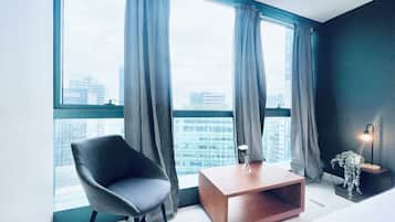 Deluxe Condo, City View | Living area | 55-inch Smart TV with digital channels