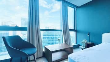 Deluxe Condo, City View | Living room | 55-inch Smart TV with digital channels