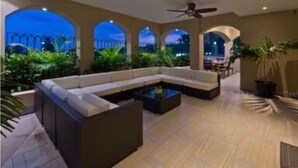 An indoor patio with a seating area, ceiling fans, and a view of the night sky. - Casa Famlee - Duplex House(sleeps 8) with Pool & Hot Tub in Cabo San Lucas! (Cabo Bello)