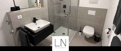 Shower, hair dryer, towels, soap