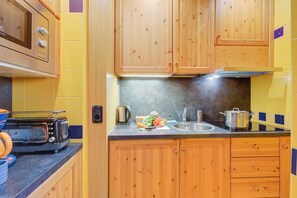 Family Apartment, Multiple Bedrooms (Giglio) | Private kitchen | Microwave, stovetop, coffee/tea maker, electric kettle