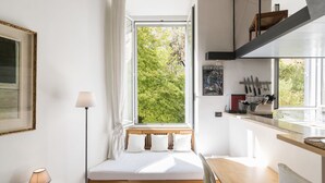 A compact room with a bed, a desk, and a window overlooking greenery. - Marsicum by Interhome (Rome: Historical City Center)