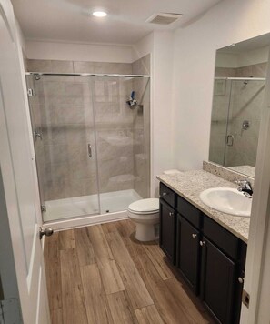 Shower, hair dryer, towels, toilet paper