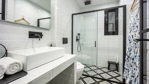 A modern bathroom with a white sink, mirror, and tiled floor. - 2BRCozy Urban Retreat Exarchia (Athens)