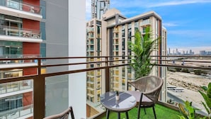 A balcony with a view of a cityscape, featuring modern buildings and a clear sky. - FIRST CLASS | 2BR | Serene Retreat in Wilton (Dubai)