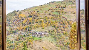 A view from a window of a hillside village with houses and autumn foliage. - Dominic by Interhome (Nendaz)