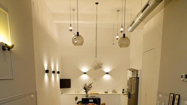 A modern living room with a sofa, a coffee table, and a dining area in the background. - "Peral boutique Apartments: Cozy apartment in the center of Seville:  (Sevilla)