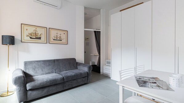 Relax in this stylish space with a sofa, reading nook, and ample storage.