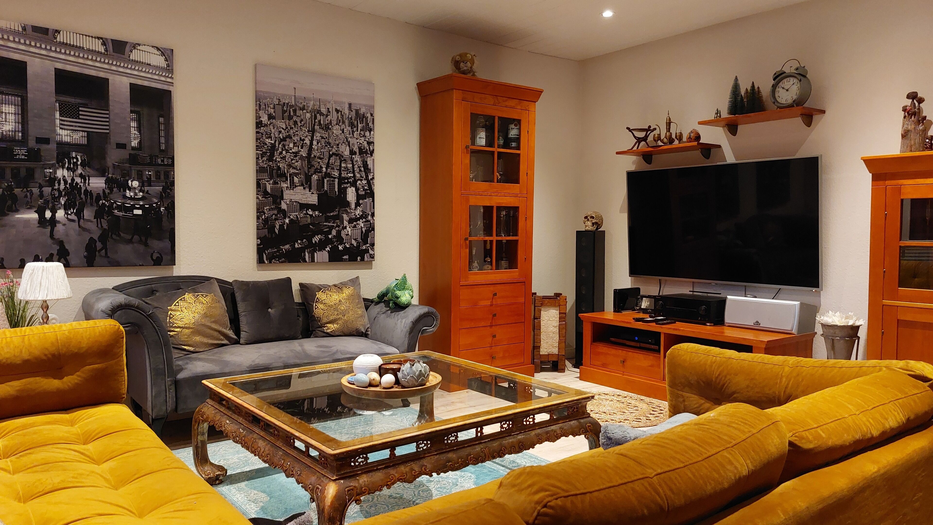 Un salon comprenant un canapé, une table basse, un téléviseur et un meuble.