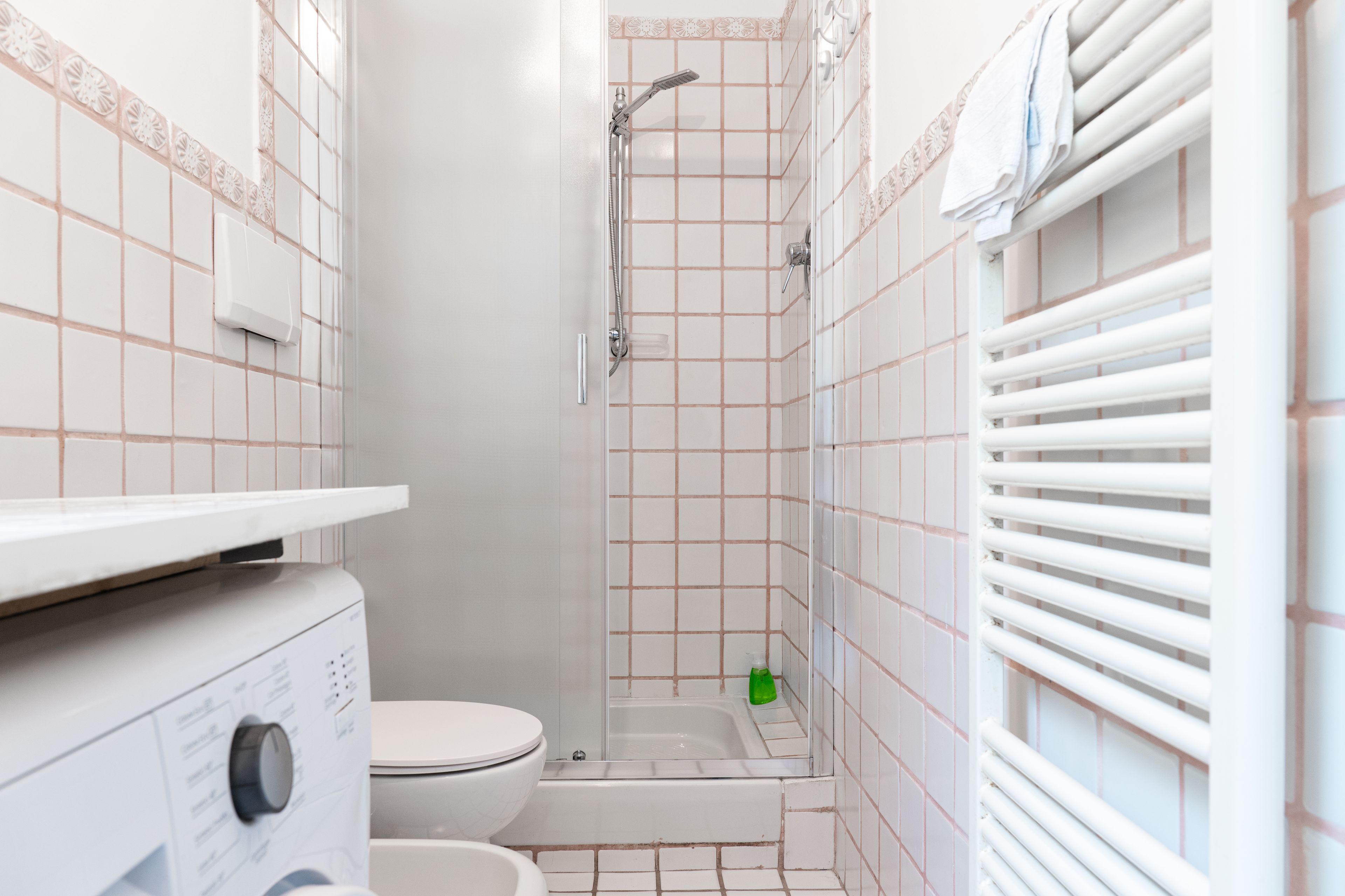A bathroom with a toilet, a shower, and a bathtub.