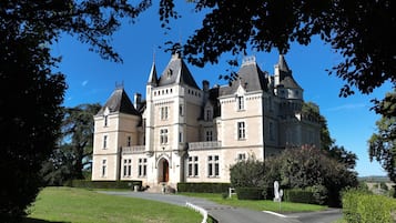 Un grand bâtiment historique doté de nombreuses tours et d’une entrée centrale.