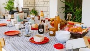 A breakfast table with various food items, utensils, and a bottle of juice. - Charming mountain B&B rooms, pets allowed with approval (Ventron)