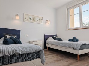A bedroom with two beds, a window, and wall-mounted light fixtures. - Authentic stay in Fontguenand with parking and breakfast included (Fontguenand)