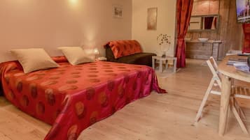 Een gezellig slaapkamer met een bed, nachtkastje en een klein bureau met stoel.