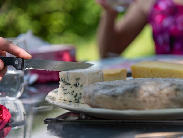 A cheese platter with a knife on a table.
