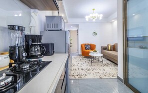 Deluxe Apartment, Balcony, City View | Living area | 24-inch Smart TV with digital channels - Lux Suites Winchester Gardens Riverside (Nairobi)