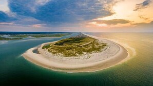 An aerial view of a coastal island with a sandy beach and surrounding water. - Ocean Echos – Luxury Oceanfront Vacation Rental in North Topsail Beach (North Topsail Beach)