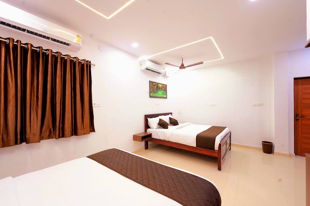 A modern bedroom with a bed, an air conditioner, a ceiling fan, and a painting on the wall.