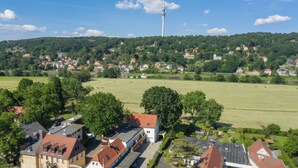 A residential area with houses, a tower, and a large open field. - apartment for 4 people with kitchen & balcony, view of the Elbe & free Wi-Fi (Dresden)