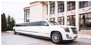 A white limousine parked in front of a building with large windows and columns. - FREE LIMO, 2 ACRES Ranch 6 Rooms 3bath Sleeps 26 (Austin)