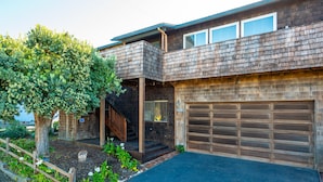 A two-story house with a garage, a covered porch, and a tree in the front yard. - Welcome to 'Ocean Oasis' Located on Park Hill in Cambria! (Cambria)