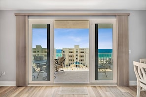 Enjoy ocean views from the balcony with a sliding glass door leading to a spacious room.