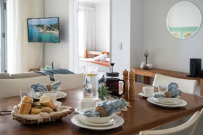 Enjoy a warm breakfast at the dining table, complete with a selection of bread and pastries.
