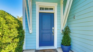 A blue door with a white frame, a welcome mat, and a potted plant beside it. - 1 Mi to Beach: Family-friendly Hilton Head Retreat (Hilton Head Island)