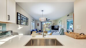 A modern kitchen with a built-in sink, a toaster, and a window with blinds. - Walk to Beach & Bites! St Augustine Resort Condo (St. Augustine)