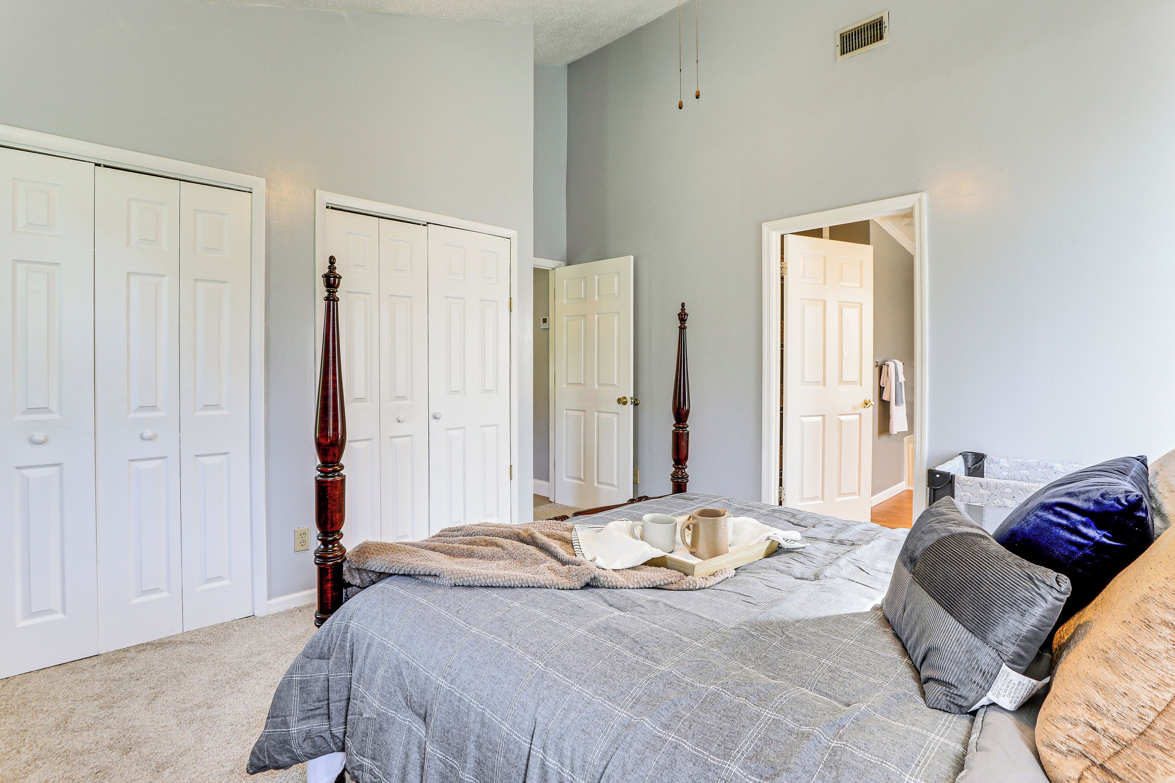 A bedroom with a bed, a nightstand, and a wardrobe.