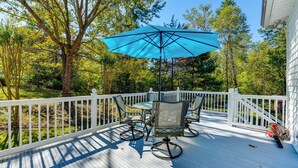 A deck with a table and chairs, a blue umbrella, and a white railing. - 1 Mi to Dtwn: Home w/ Fire Pit & Deck in Hudson! (Hudson)