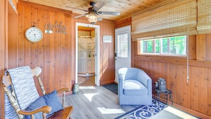 A wooden interior with a wooden ceiling, a ceiling fan, a clock, a door, and a window with blinds. - Unwind Near the Lake Fire Pit Marina Nearby (Bronston)