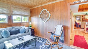 A wooden interior with a sofa, rocking chair, and a 'Welcome' sign. - Unwind Near the Lake Fire Pit Marina Nearby (Bronston)