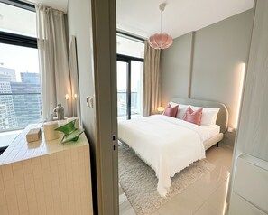 Relax in a spacious room with a large bed, city views, and a minimalist design.