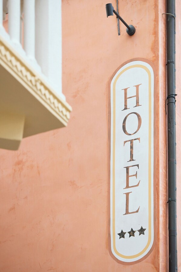 A hotel sign with the word 'HOTEL' and three stars.