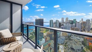 A balcony with a city view, a sofa, and a table. - Bright Studio | Concierge | Near Miami Worldcenter (Miami)