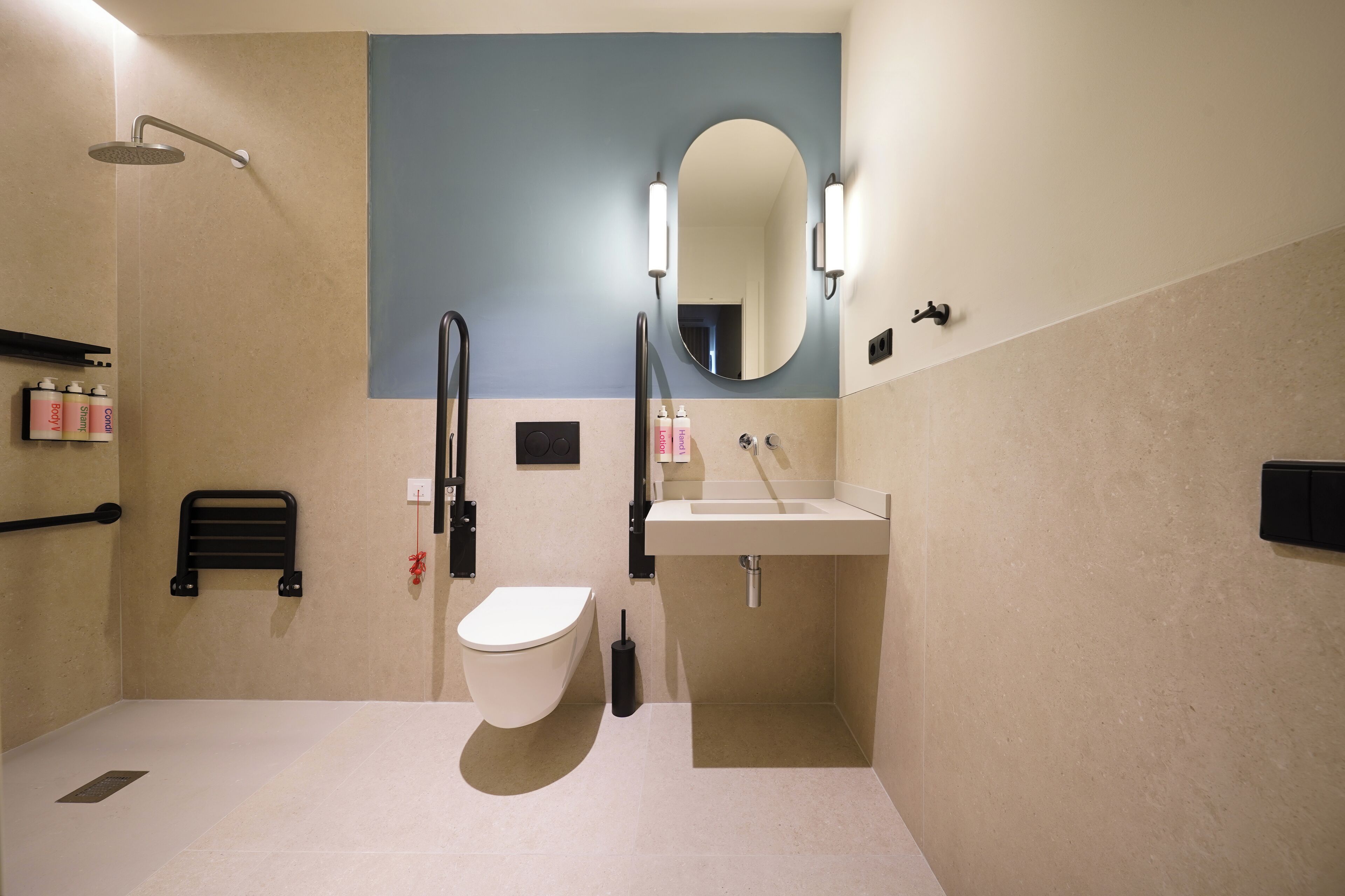 A modern bathroom with a toilet, sink, and shower.