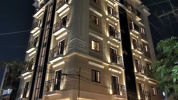 A multi-story building with balconies and illuminated windows at night. - Western Suites (Hyderabad)