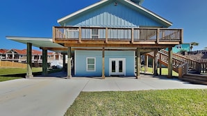 A two-story house with a balcony and a covered porch.