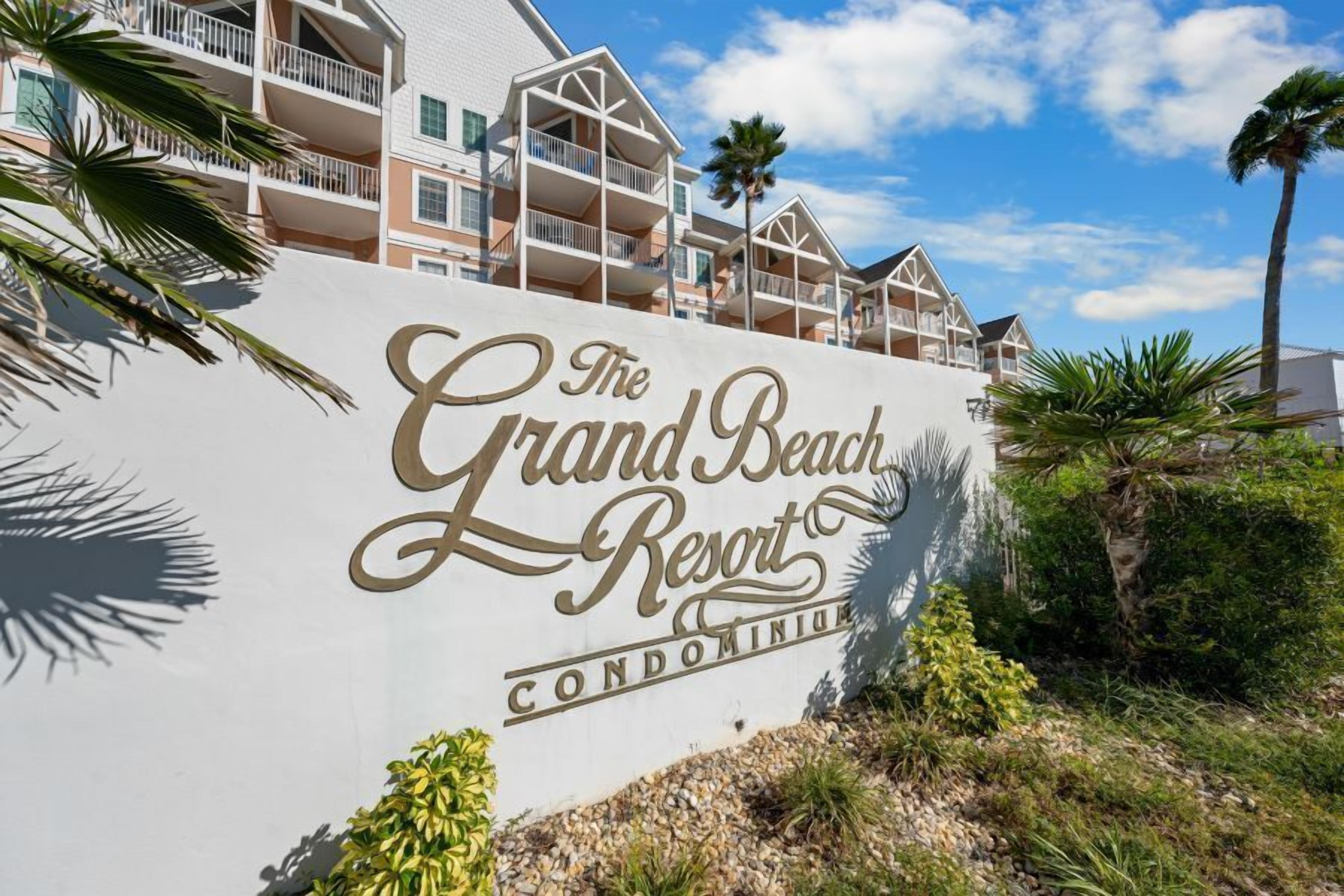 A sign for The Grand Beach Resort, indicating it is a condominium property.