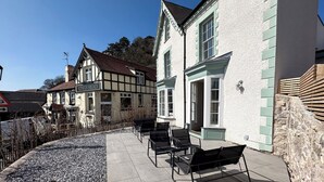 A traditional pub named 'Kings Head' with outdoor seating and a gravel path.