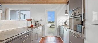Pool and activity house with a 180-degree view of the North Sea, located at.