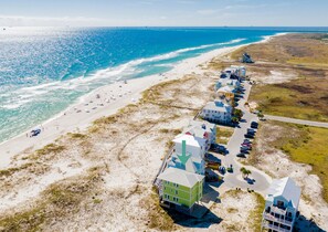 A coastal hotel with a beach view, multiple-story buildings, and a parking area. - Gulf Front Retreat | Private, Heated Pool | Pet-Friendly (Gulf Shores)
