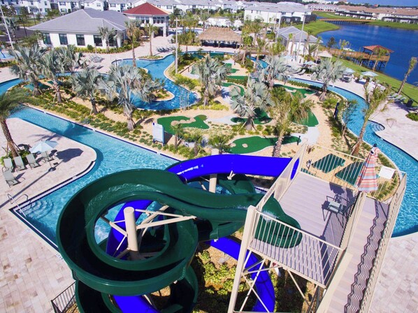 A resort with a large water slide, multiple pools, and a golf course. - Amazing 5Bdrms At Storey Lake (Kissimmee)