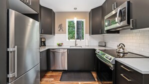 A modern kitchen with stainless steel appliances, a dishwasher, and a stove.